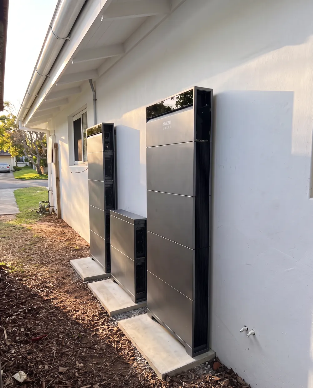 Three home batteries installed along the side of a Northern NSW home